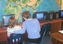 Sunday School student and instructor viewing a multimedia Bible story